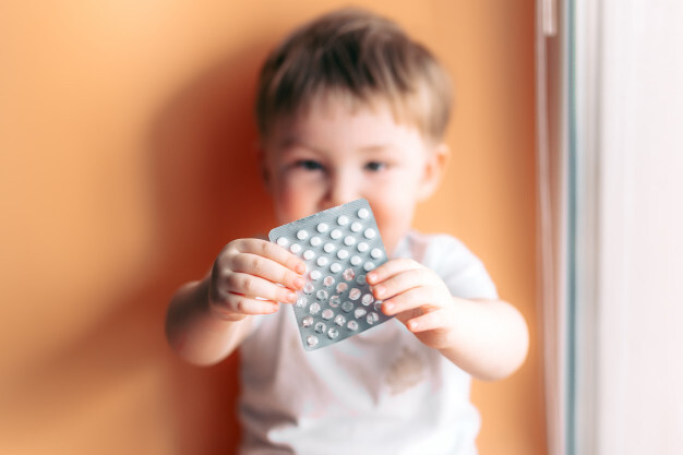 a-small-child-toddler-baby-boy-holds-a-plate-with-pills-in-his-hands-selected-focus-on-pills-kid-unfocused_93267-477
