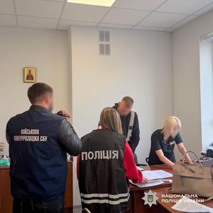 Фото: Національна поліція України. Поліцейські та військова контррозвідка перевіряють документи в медзакладі.